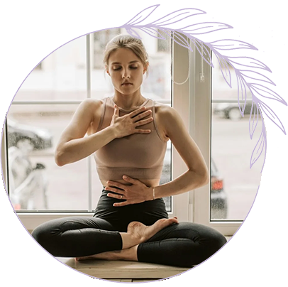 Polyvagal-Informed Breathwork and Nervous System Regulation Woman practicing mindfulness breathing with hand on chest and stomach to support nervous system regulation and polyvagal therapy