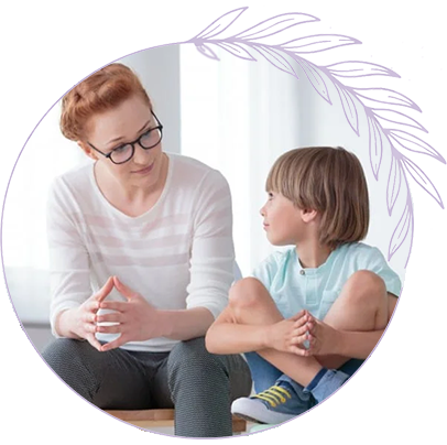 Child Therapy Session with Compassionate Therapist Therapist sitting on the floor speaking with a young child in a calm, supportive setting