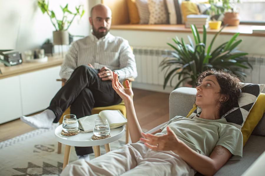 Client speaking with a therapist during an EMDR therapy intake session in a comfortable counseling office.